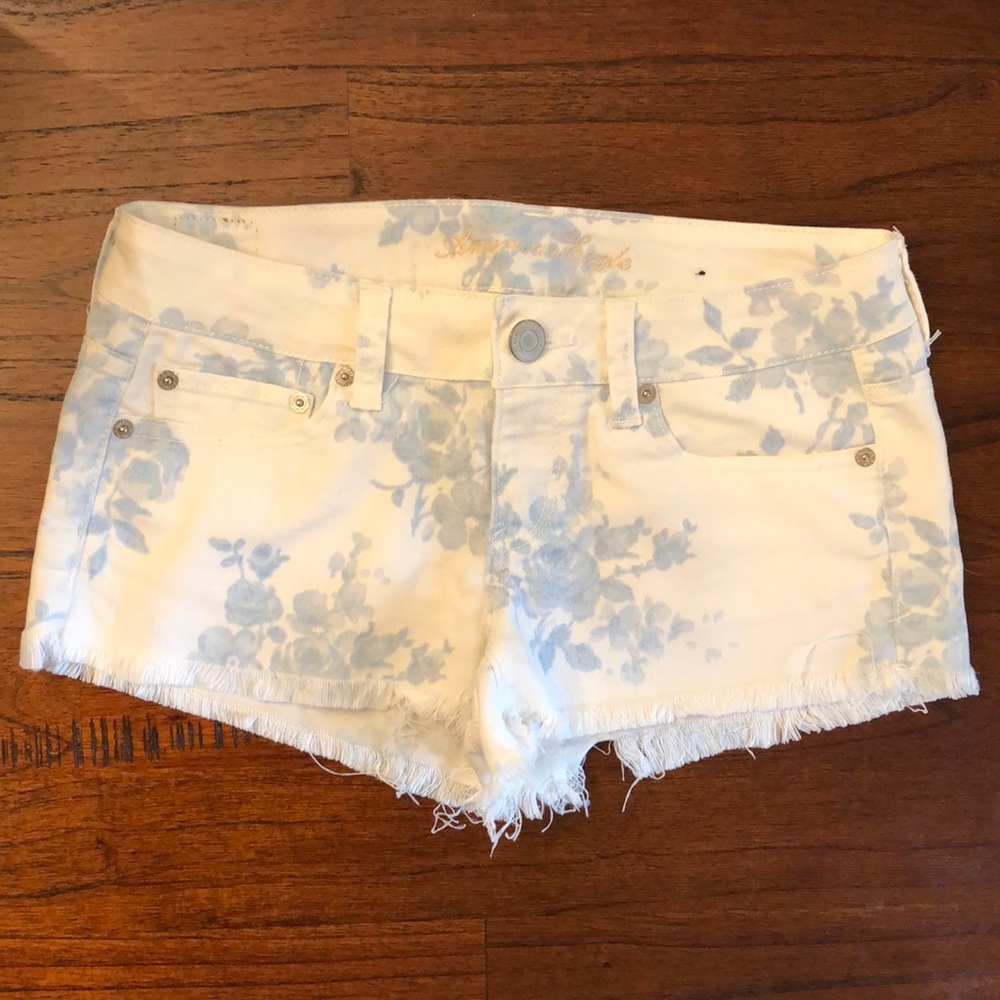 White denim shorts w/ blue flowers